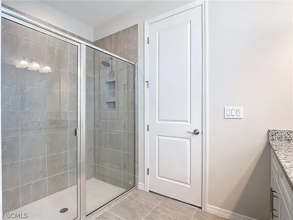 a bathroom with a glass shower door