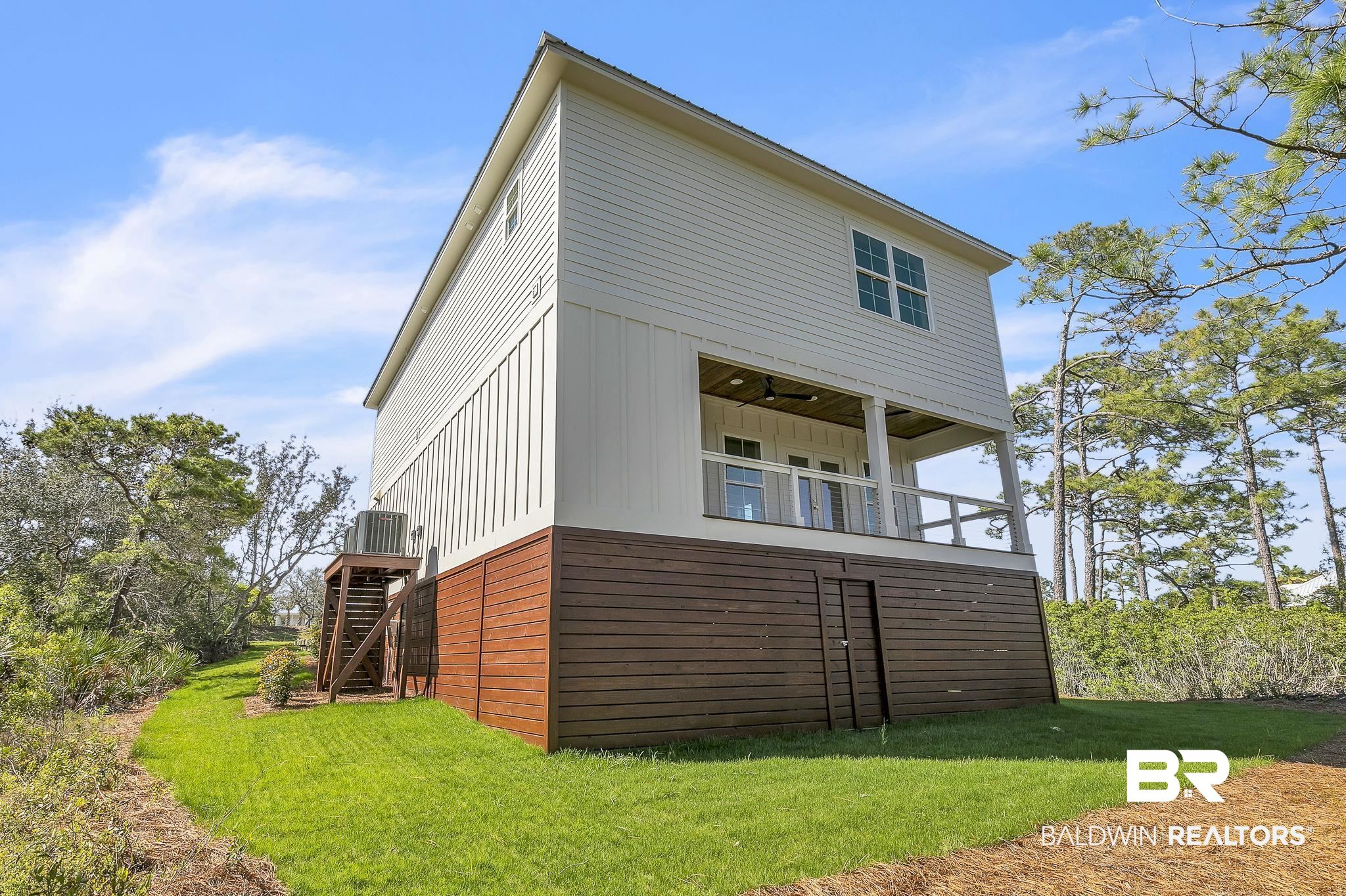 30449 River Road Orange Beach, AL 36561 - Photo 27 of 39 Back of property featuring stairway and a lawn