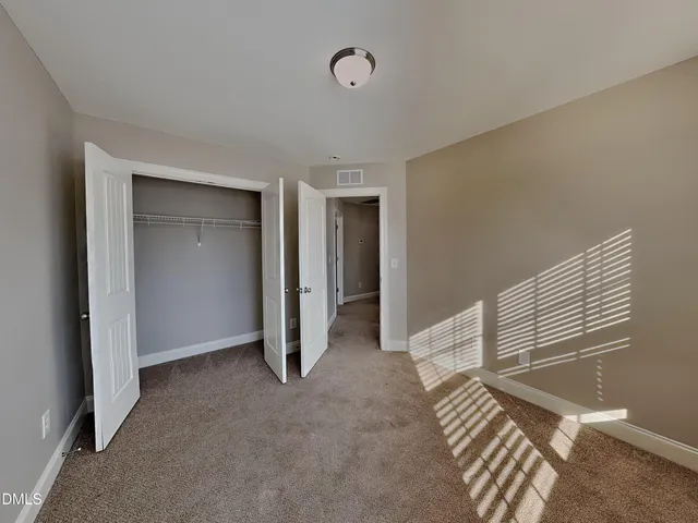a view of a livingroom with wooden floor and stairs