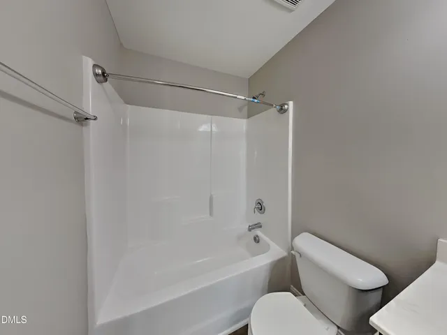 a bathroom with a toilet and a bathtub