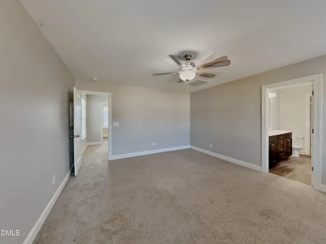 an empty room with closet and windows