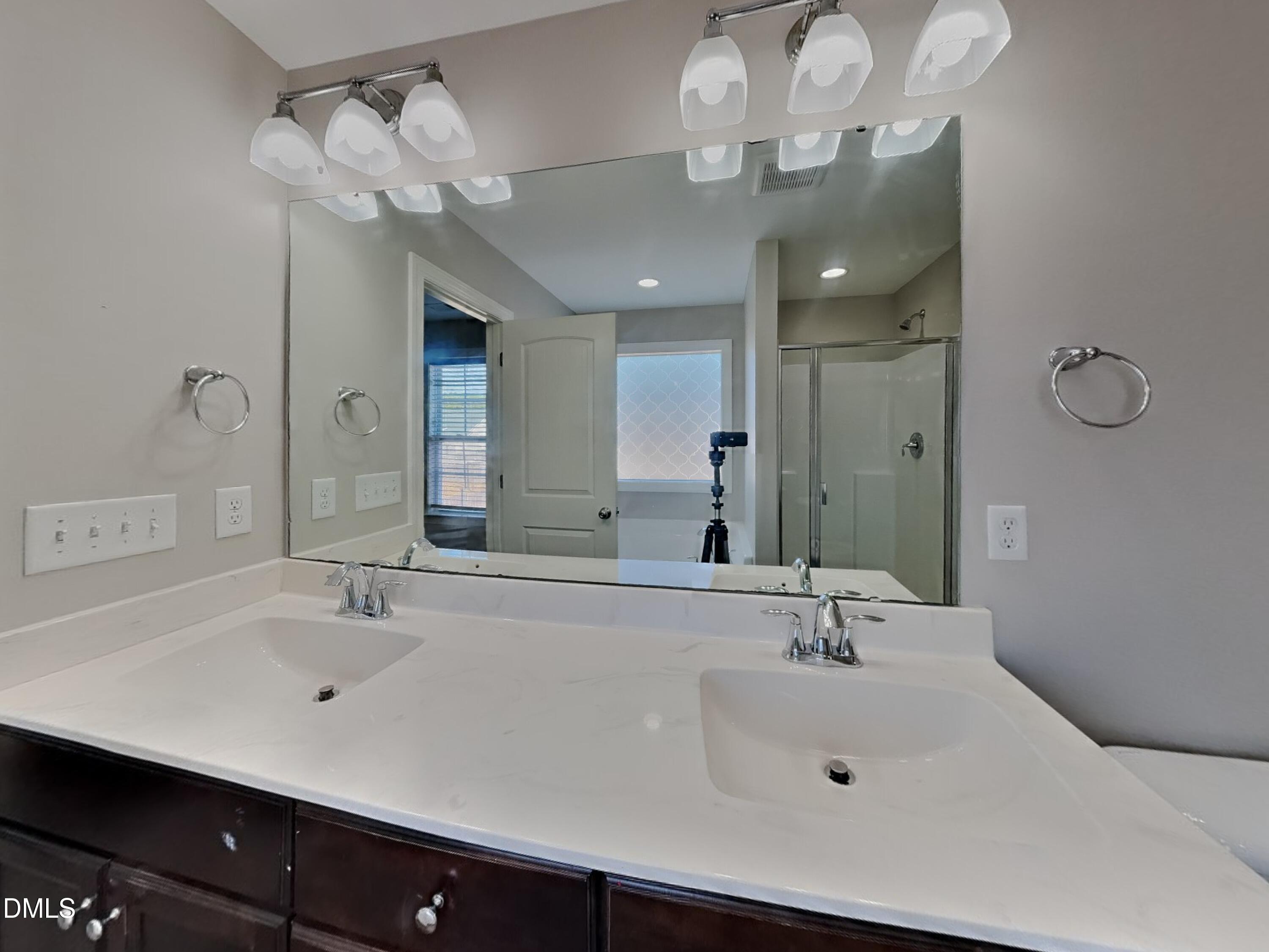 93 Jonalker Court Clayton, NC 27520 - Photo 7 of 17 a bathroom with a sink double vanity and a mirror