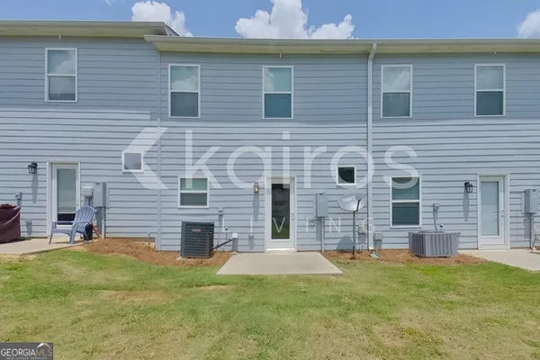 a brick house that has a large area in front of it