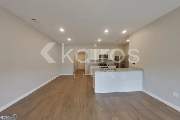 a living room with kitchen island furniture and a wooden floor
