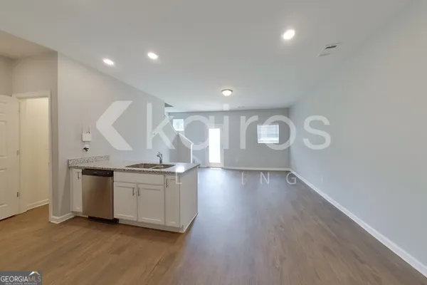 a view of a kitchen with stove and wooden floor