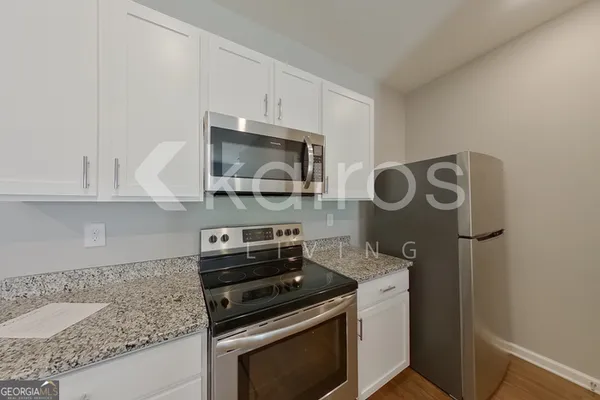 a kitchen with stainless steel appliances granite countertop a stove and a microwave