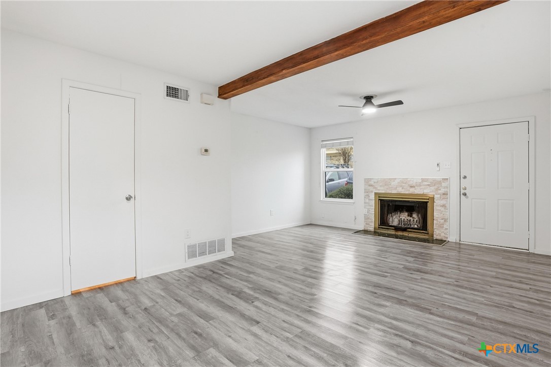 922 North 7th Street Copperas Cove, TX 76522 - Photo 6 of 26 a view of an empty room with wooden floor fireplace and a window