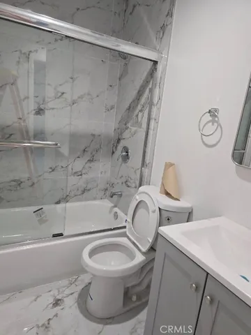 a bathroom with a toilet and a bathtub