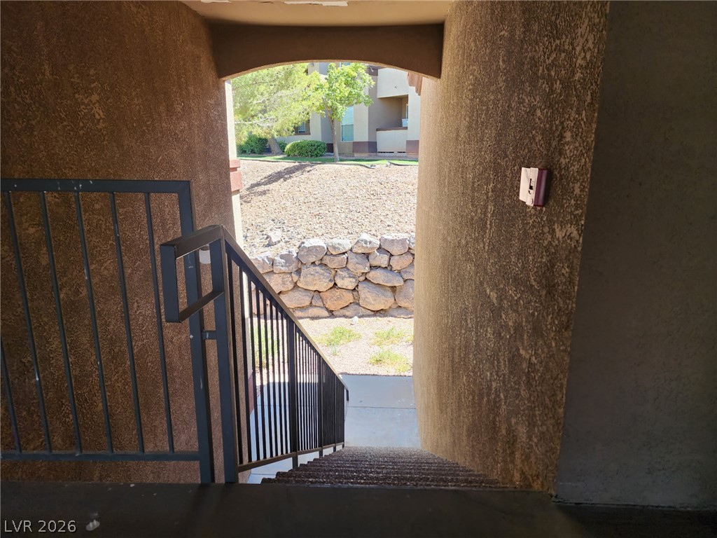 231 West Horizon Ridge Parkway, Unit 1127 Henderson, NV 89012 - Photo 36 of 39 A well-maintained outdoor stairway descends, framed by sturdy metal railings and natural stonework.