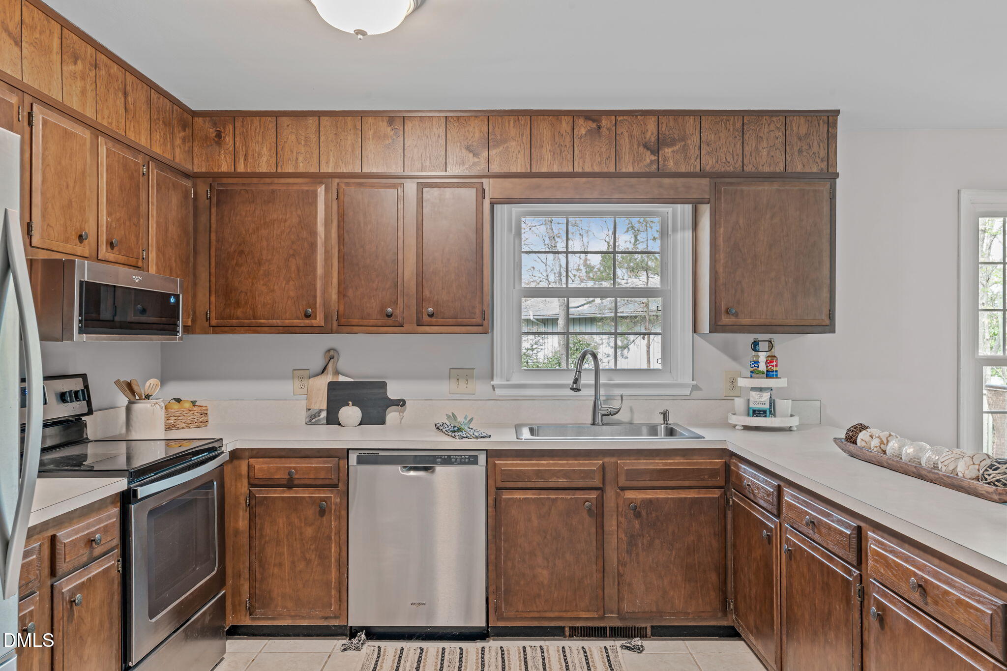 3304 Wade Avenue Raleigh, NC 27607 - Photo 13 of 38 a kitchen with a sink cabinets and window