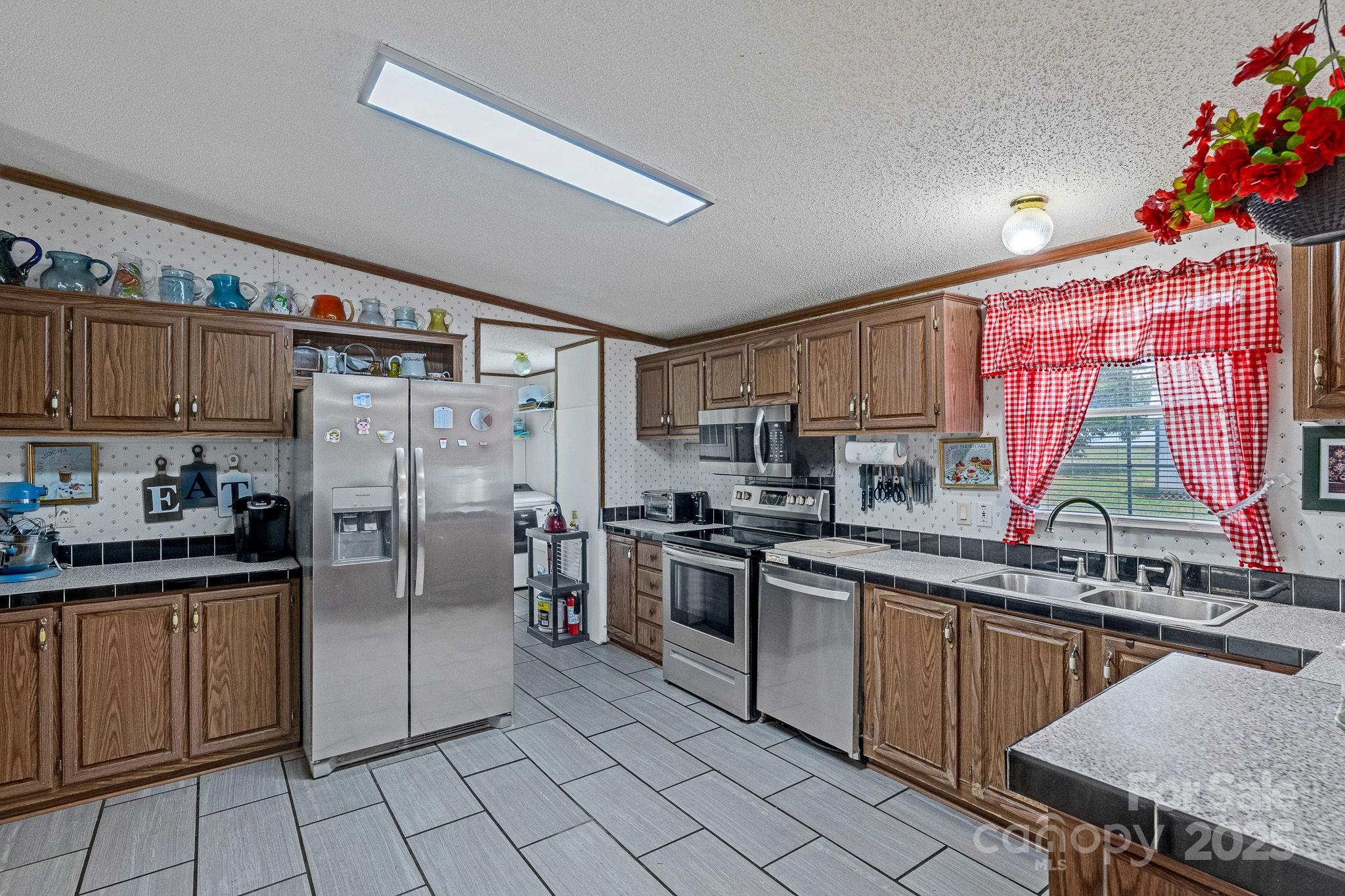 1107 Richard Road Salisbury, NC 28147 - Photo 12 of 35 a kitchen with stainless steel appliances a sink cabinets and a counter top space