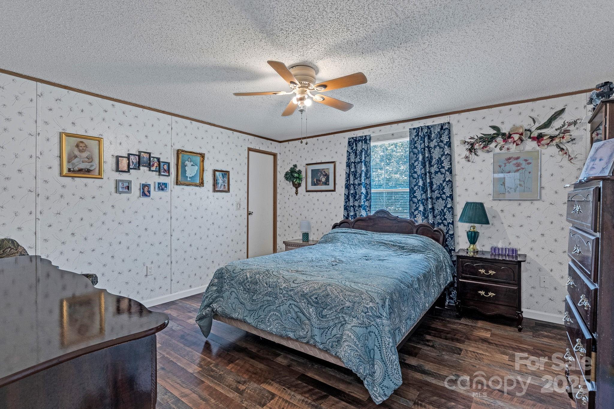 1107 Richard Road Salisbury, NC 28147 - Photo 24 of 35 a bedroom with a bed and a chandelier
