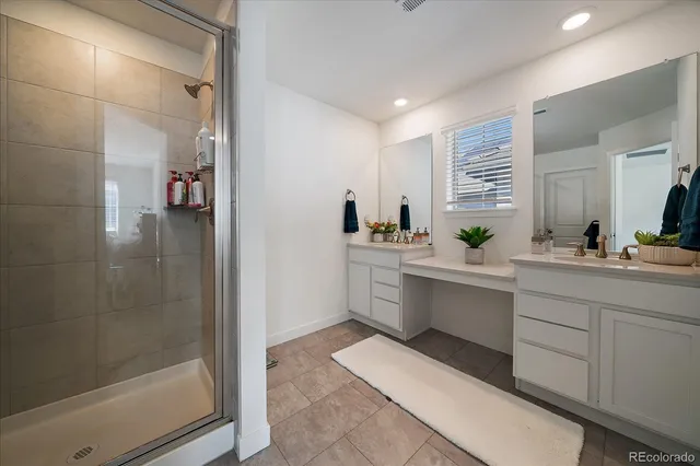 a bathroom with a glass shower door