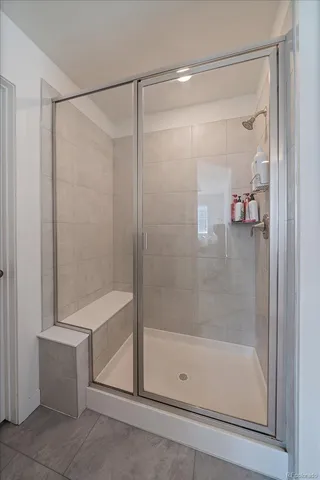 a bathroom with a toilet a sink a mirror a bathtub and vanity