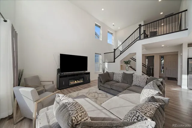 a living room with furniture or couch and a chandelier