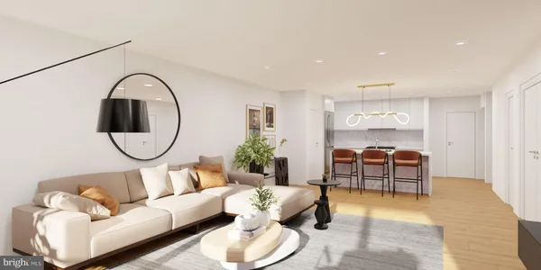 a living room with furniture and a mirror