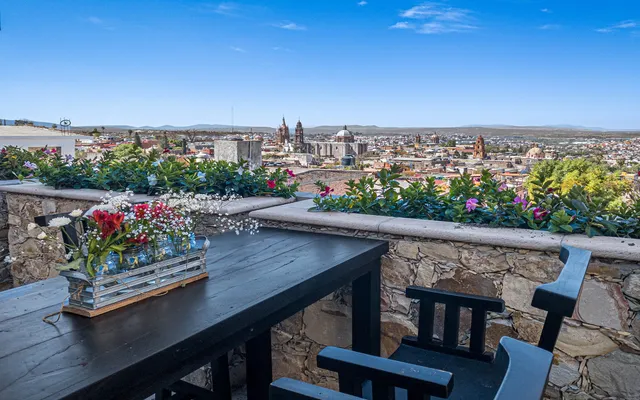 a city view from a balcony with outdoor seating