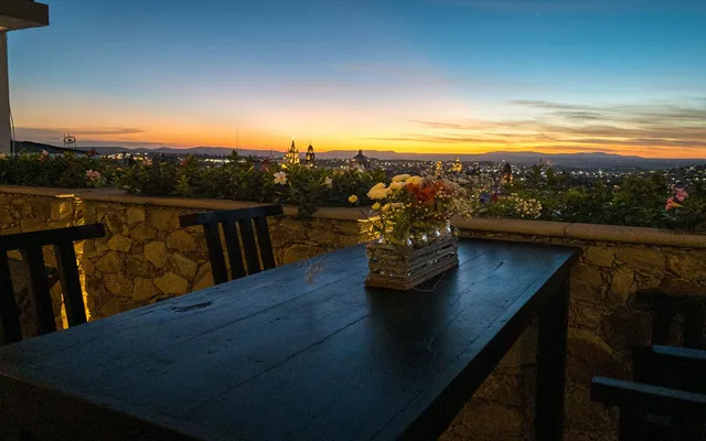 a view of roof deck with ocean view and mountain view