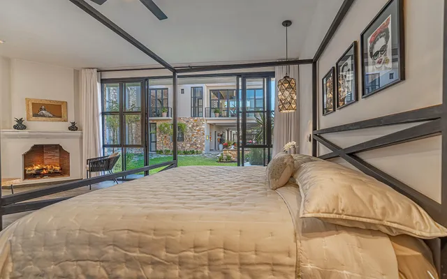 a bed sitting in a bedroom next to a large window