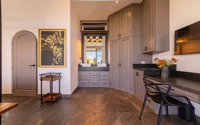 a view of a workspace with furniture and a window