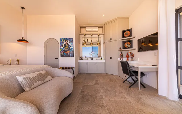 a bedroom with a bed window and chair