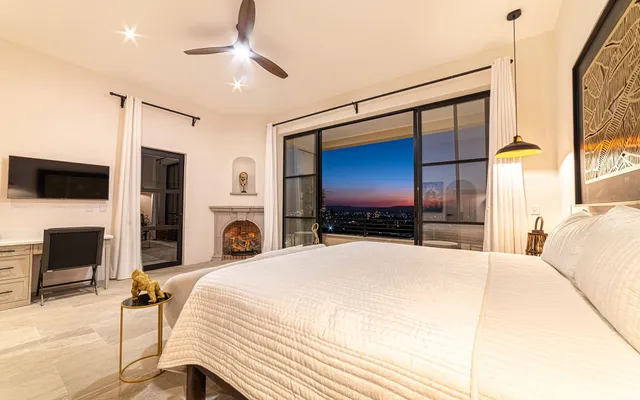 a bedroom with a bed and a flat screen tv