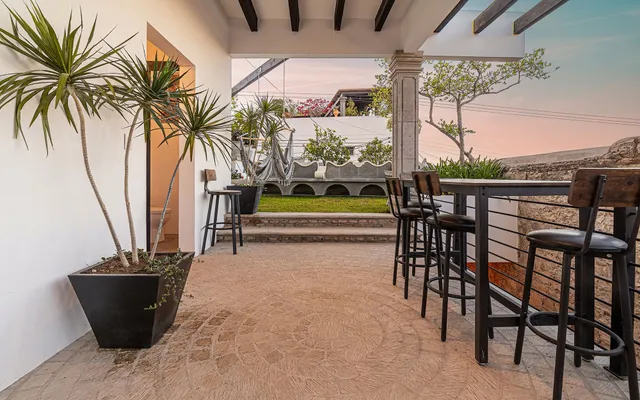 a view of a chairs and table in patio