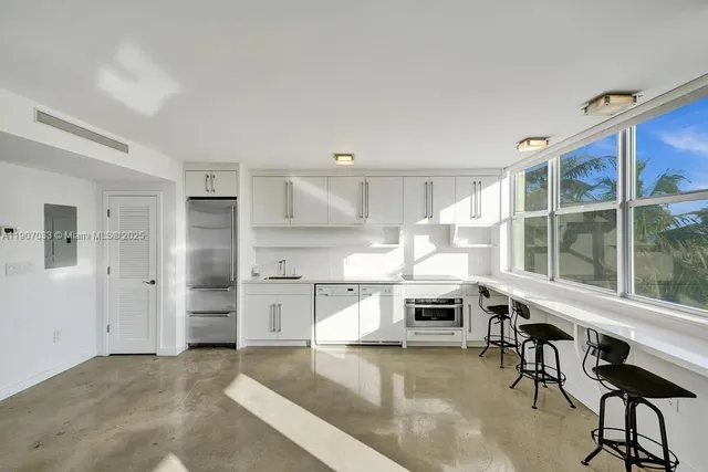 a kitchen with stainless steel appliances a stove a sink and a refrigerator
