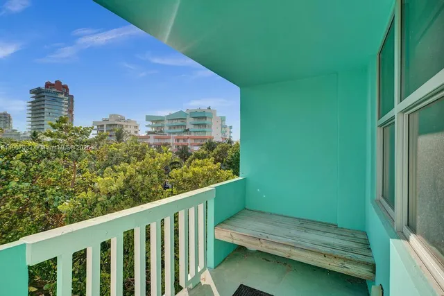 a balcony with trees in front of it