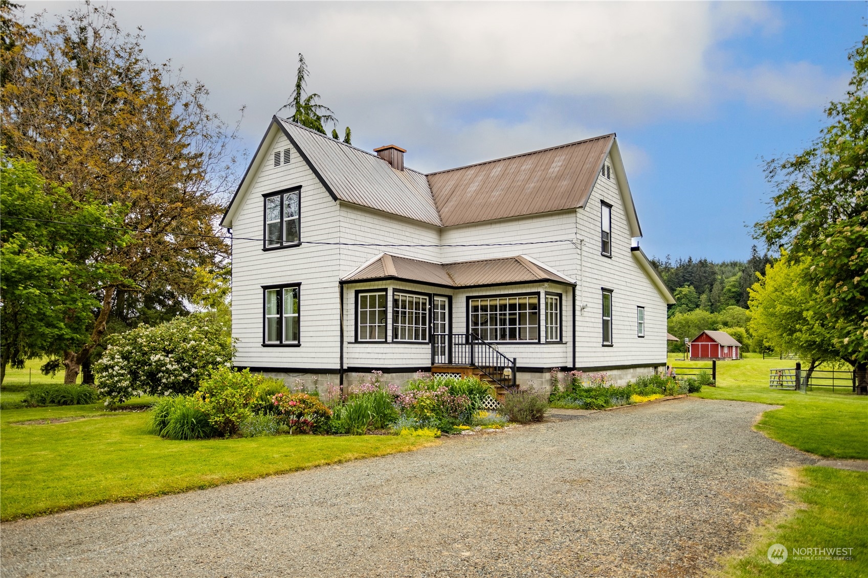 12129 Independence Road Southwest Rochester, WA 98579 - Photo 1 of 37 a front view of a house with a garden