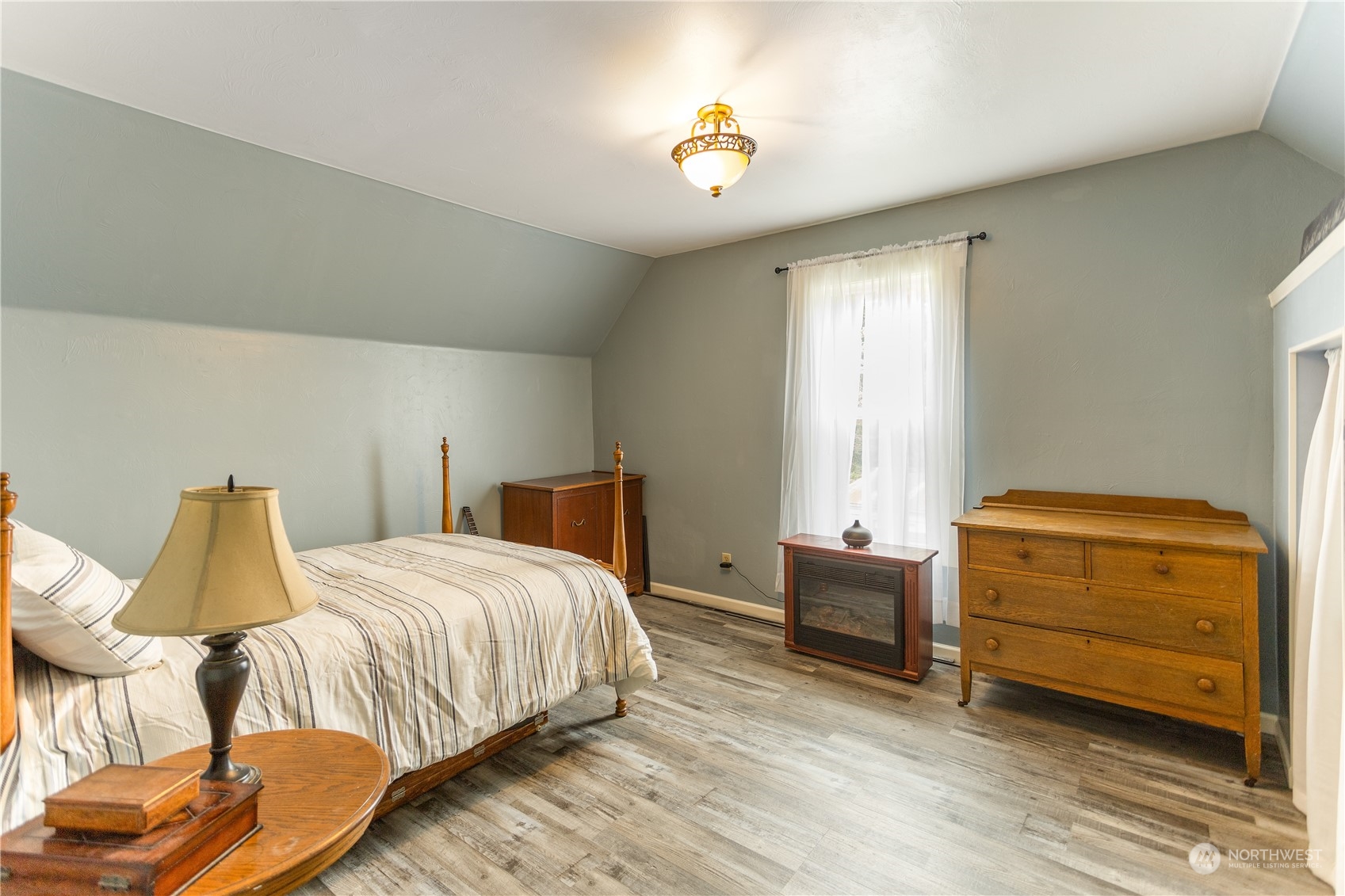 12129 Independence Road Southwest Rochester, WA 98579 - Photo 24 of 37 a bedroom with a bed and a chair