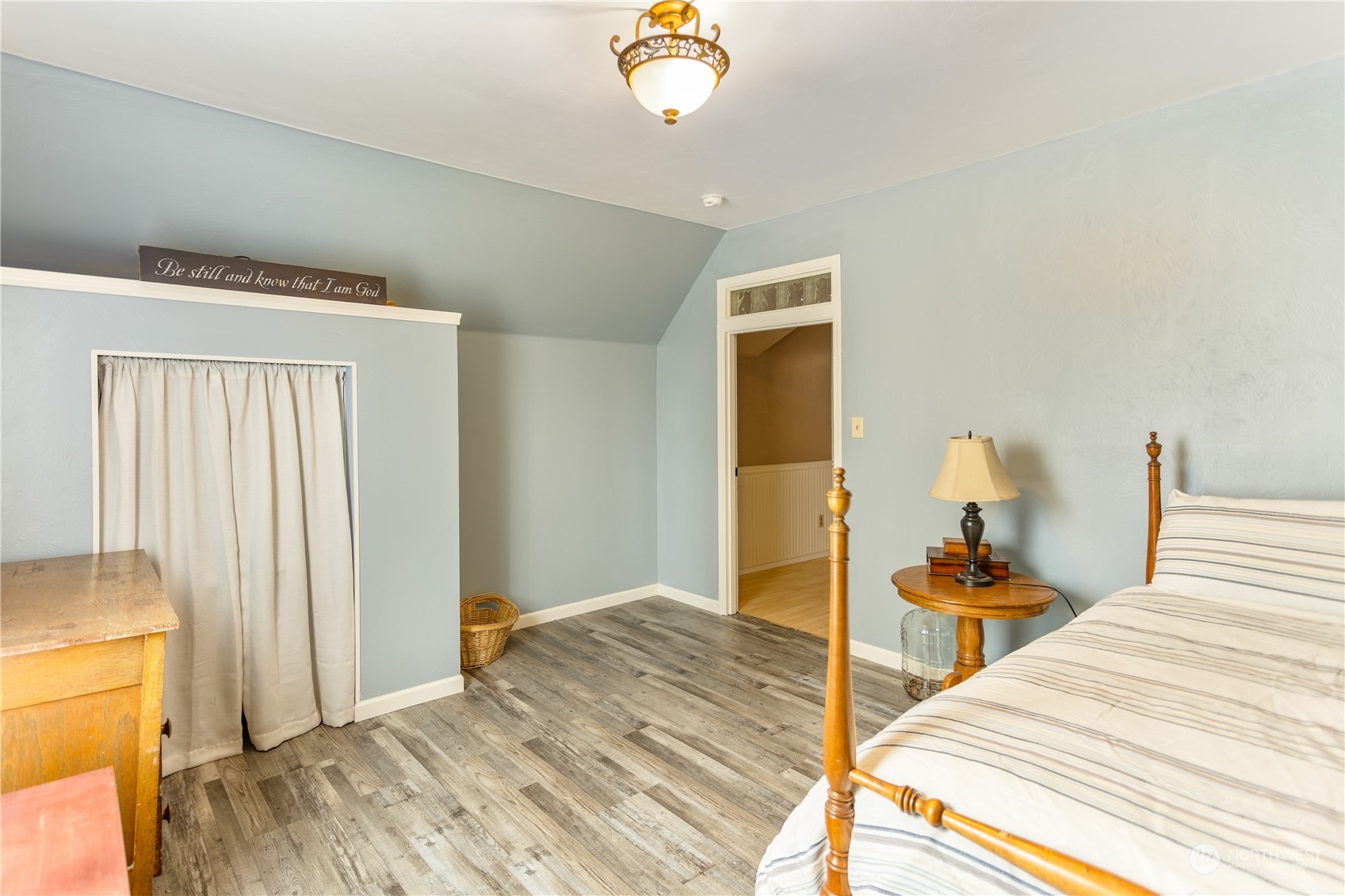 12129 Independence Road Southwest Rochester, WA 98579 - Photo 25 of 37 a bedroom with a bed and a chandelier