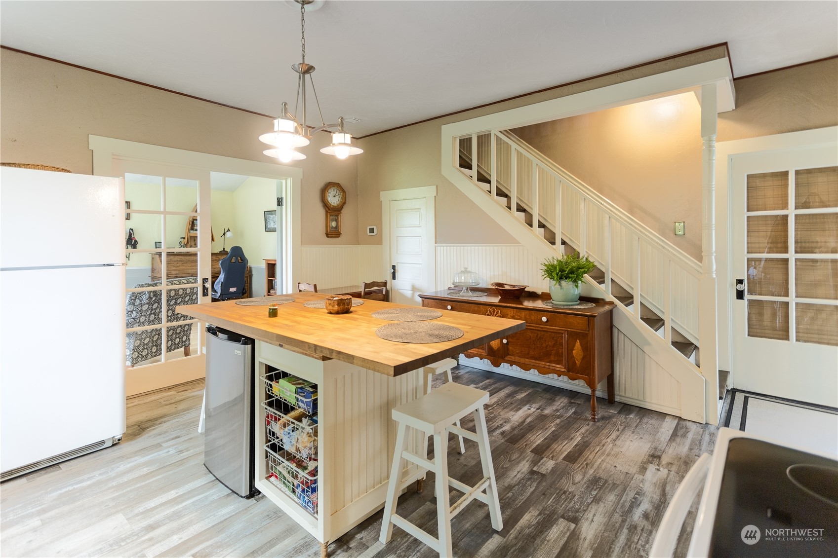 12129 Independence Road Southwest Rochester, WA 98579 - Photo 7 of 37 a room with table chairs and wooden floor