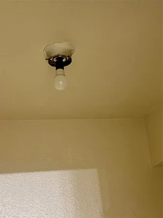 a view of a room with a ceiling fan and a window