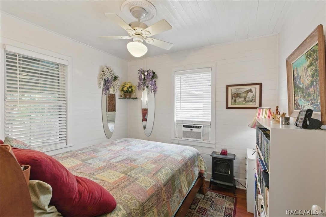 6 62nd Street Yankeetown, FL 34498 - Photo 25 of 55 a bedroom with a bed and a chandelier