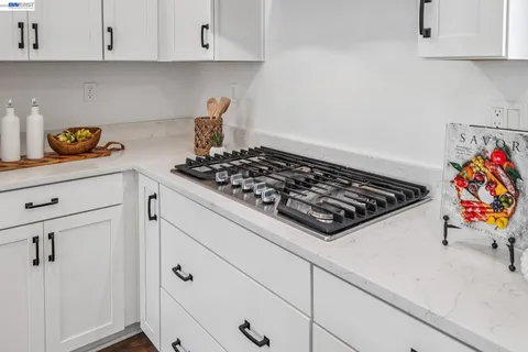 a kitchen with a dining table chairs refrigerator and cabinets