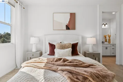 a bedroom with a large bed and a chandelier