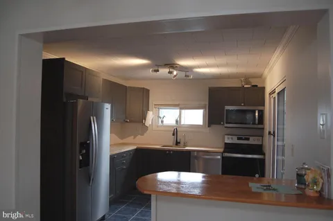 a kitchen with a refrigerator and a sink