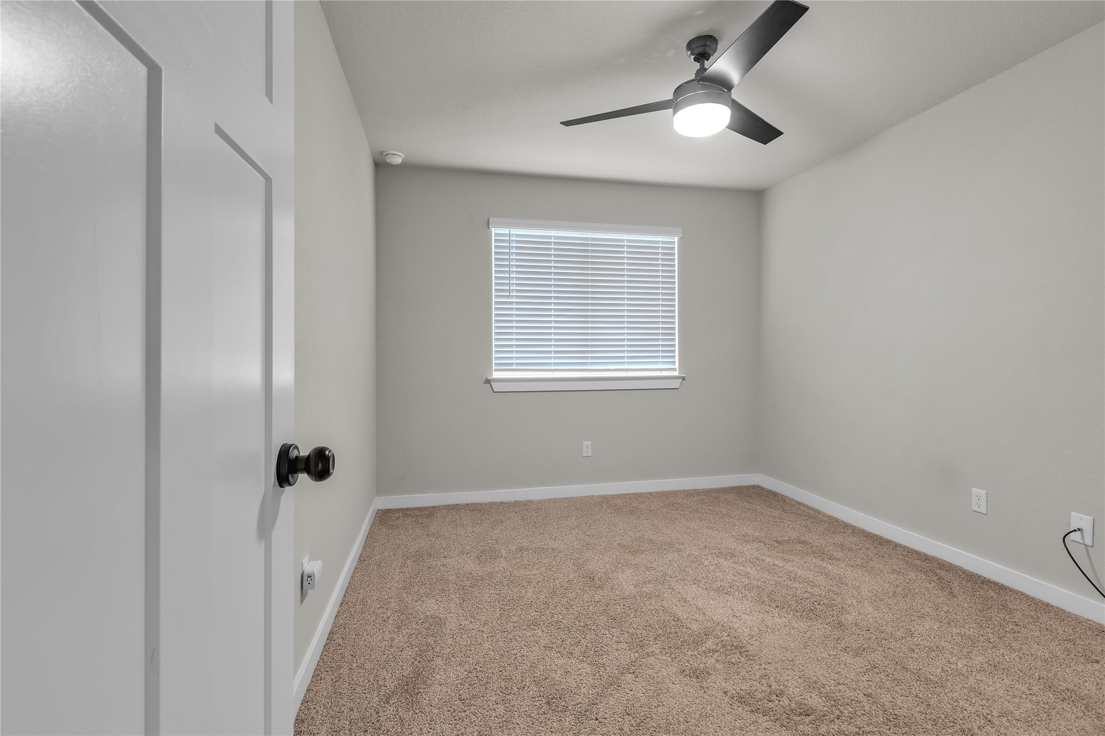 1212 Tipton Street Georgetown, TX 78633 - Photo 13 of 20 A quiet secondary bedroom offering comfortable carpeted flooring and a functional ceiling fan with lighting.