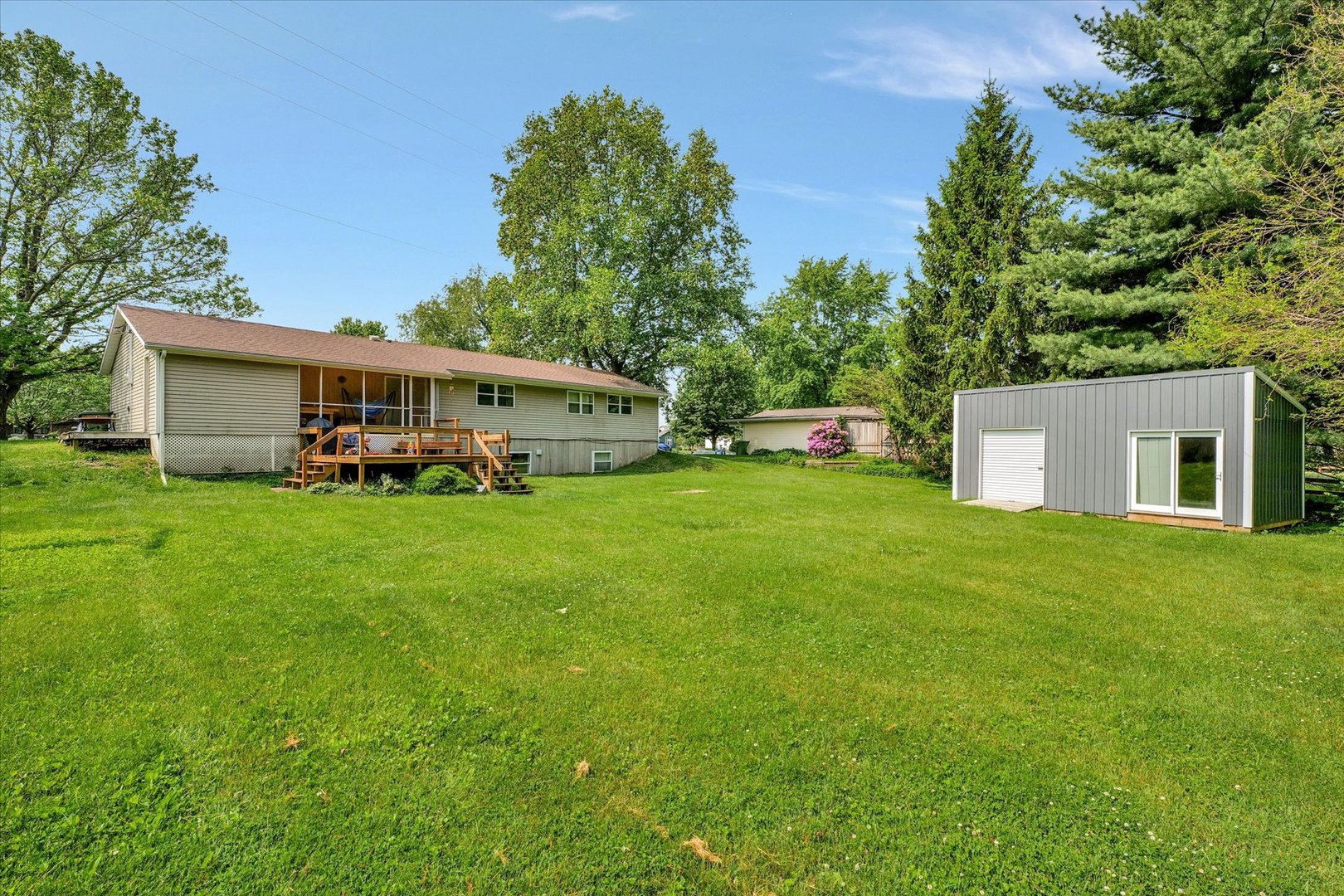 402 East South Mahomet Road Mahomet, IL 61853 - Photo 6 of 21 a view of a house with a big yard and large trees