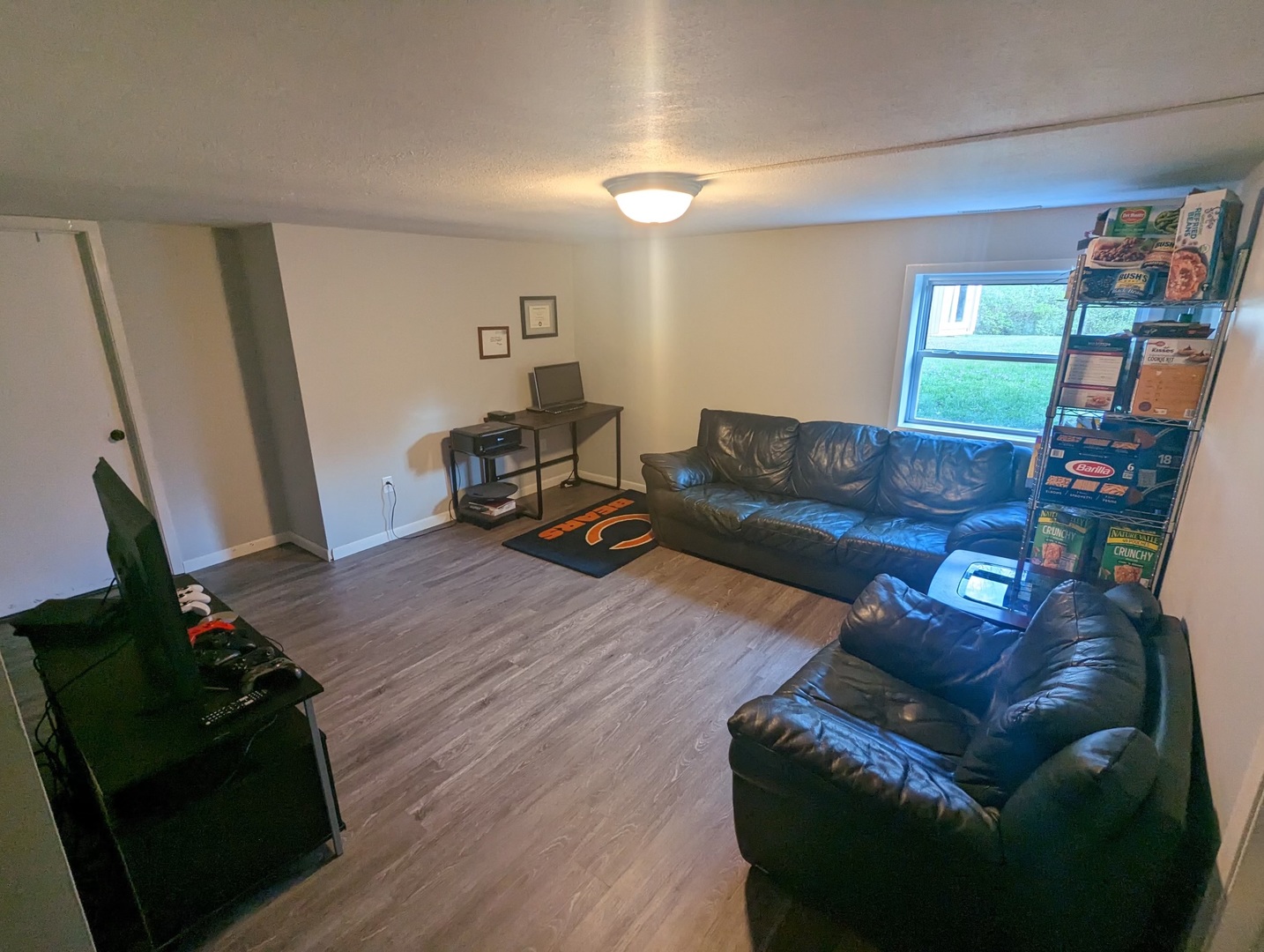 402 East South Mahomet Road Mahomet, IL 61853 - Photo 10 of 21 a living room with furniture and a flat screen tv