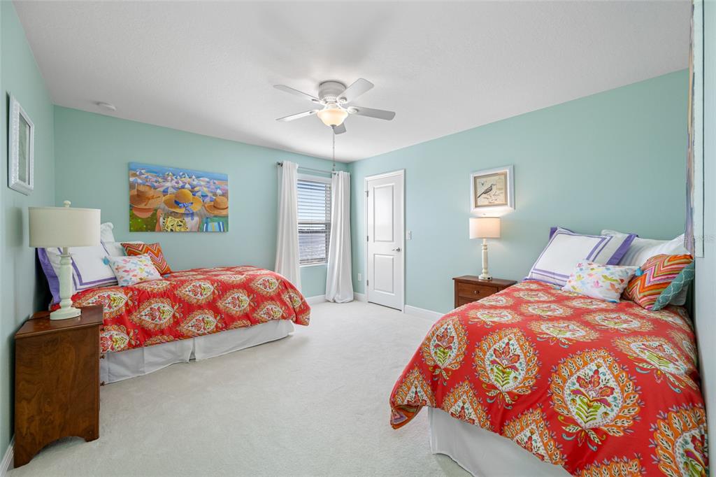 19709 Long Lake Ranch Boulevard Lutz, FL 33558 - Photo 33 of 59 a bedroom with large bed and a chandelier