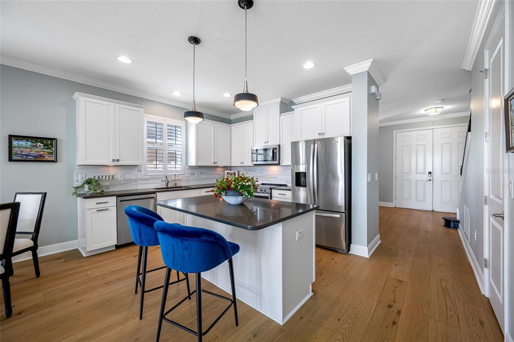 19709 Long Lake Ranch Boulevard Lutz, FL 33558 - Photo 8 of 59 a kitchen with stainless steel appliances granite countertop wooden floors and a view of living room