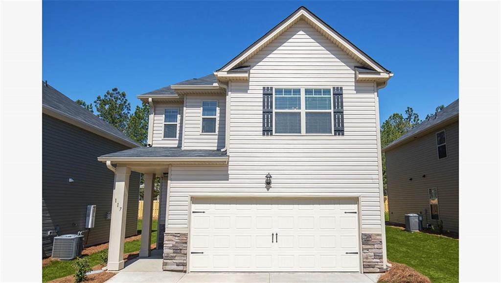 12156 Conrad Circle Hampton, GA 30228 - Photo 1 of 1 a front view of a house with a yard