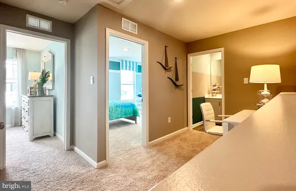 a view of a bathroom with a tub shower and mirror