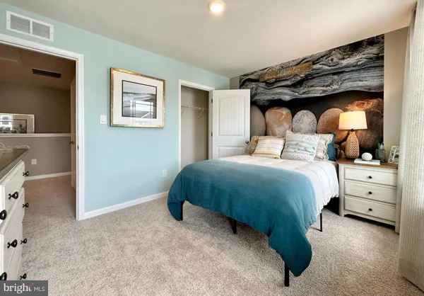 a bedroom with a bed and a dresser