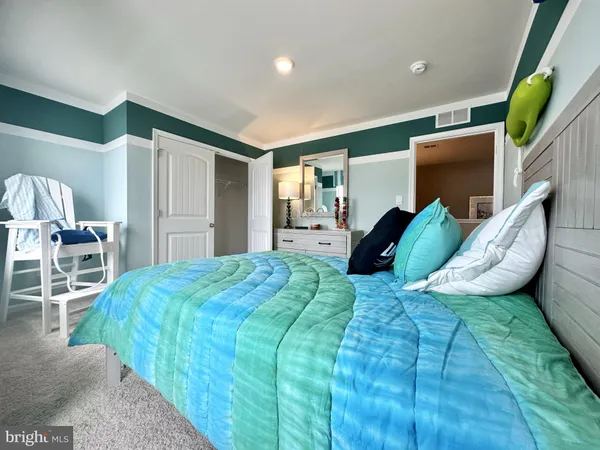 a bed room with a bed and a chair