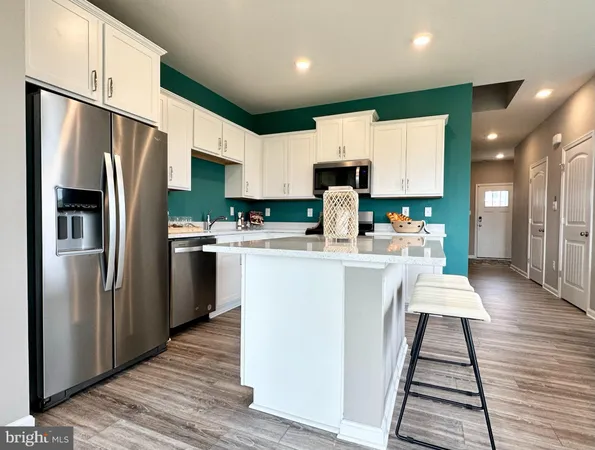 a kitchen with stainless steel appliances a refrigerator stove microwave and sink