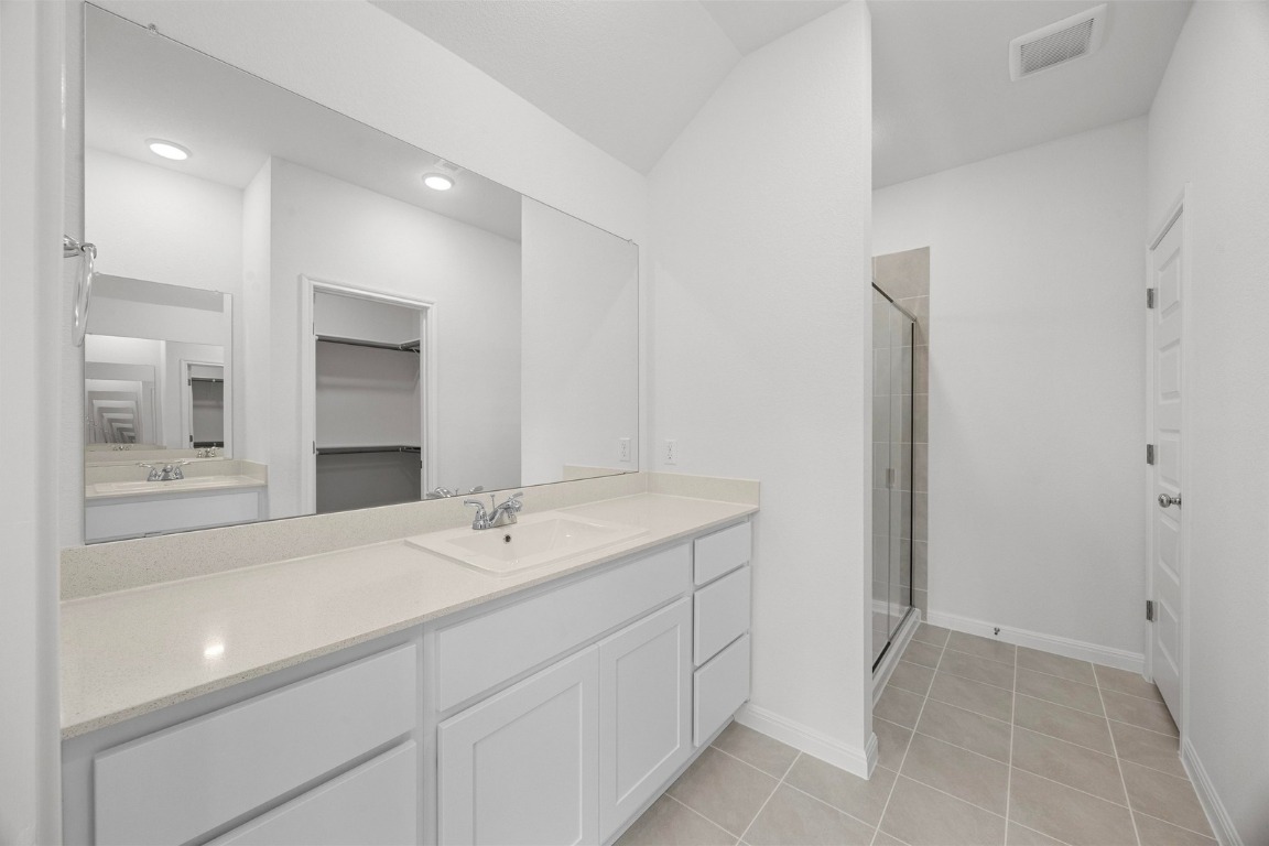 437 Lucky Avenue Elgin, TX 78621 - Photo 13 of 35 a spacious bathroom with a sink and a mirror