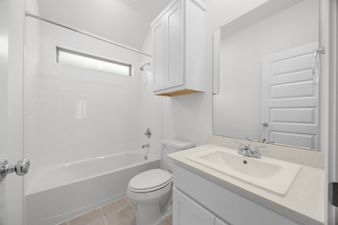 437 Lucky Avenue Elgin, TX 78621 - Photo 22 of 35 a bathroom with a sink a toilet and shower